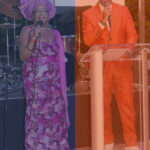 Marlon and a vocalist in a Nigerian hat on stage.