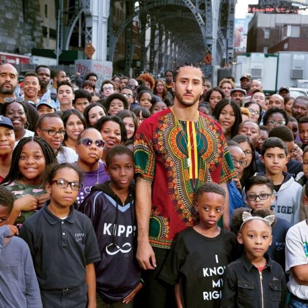 Football hero Colin Kaepernick and Marlon Rice standing among a group of Brooklyn young people.
